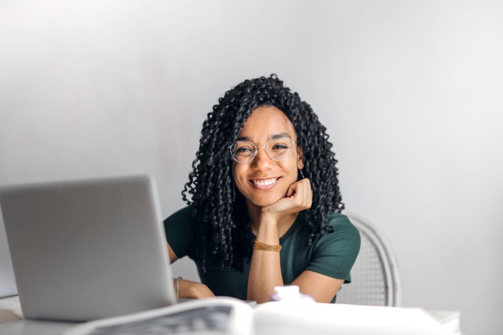 Smiling young woman working on a laptop