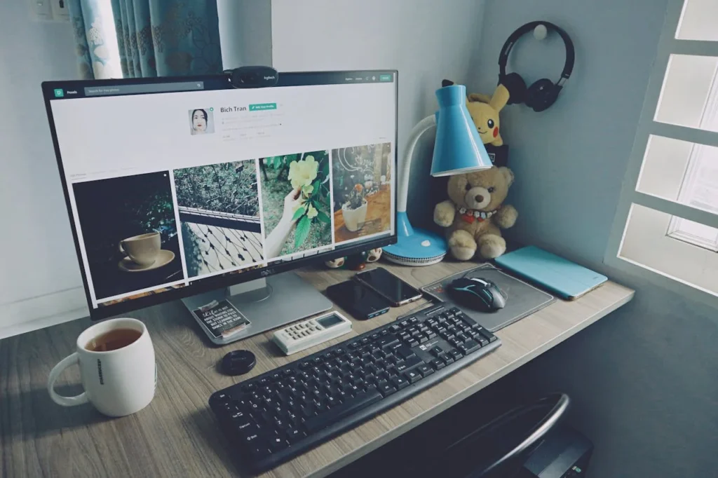 Computer workstation with a large monitor, keyboard and coffee mug